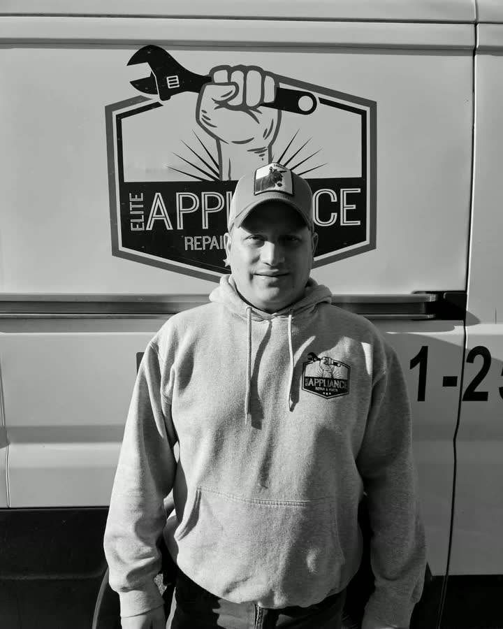 Dubán Martínez, Elite Appliance technician, in the company hoodie in front of the van